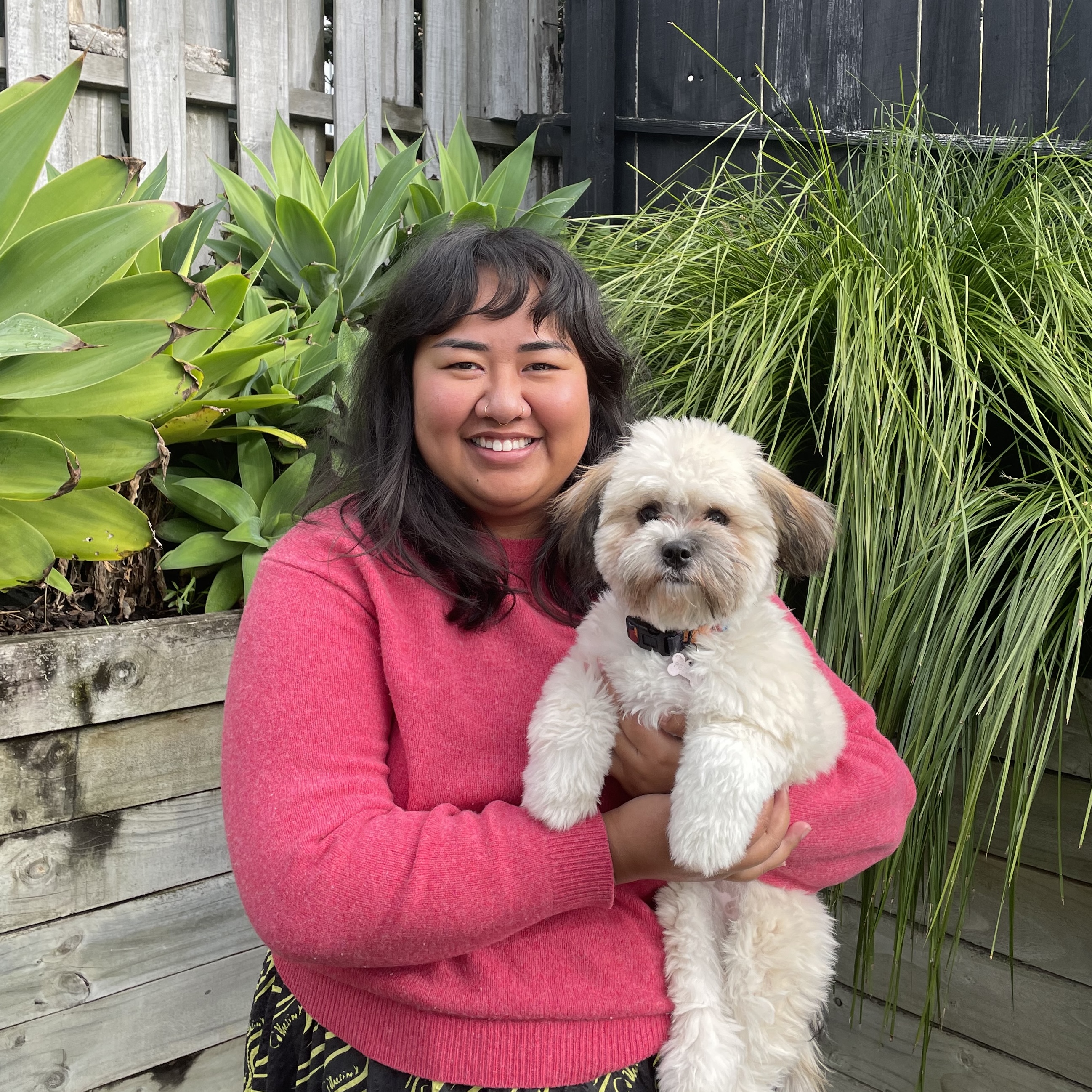 a pretty photo of Anahera smiling with greenery in the background