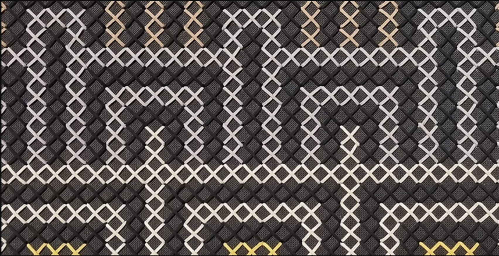 close up of a black, white and yellow tukutuku pattern